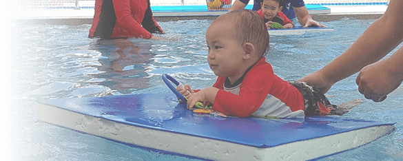 cute baby on a float in a swimming lesson in Bangkok